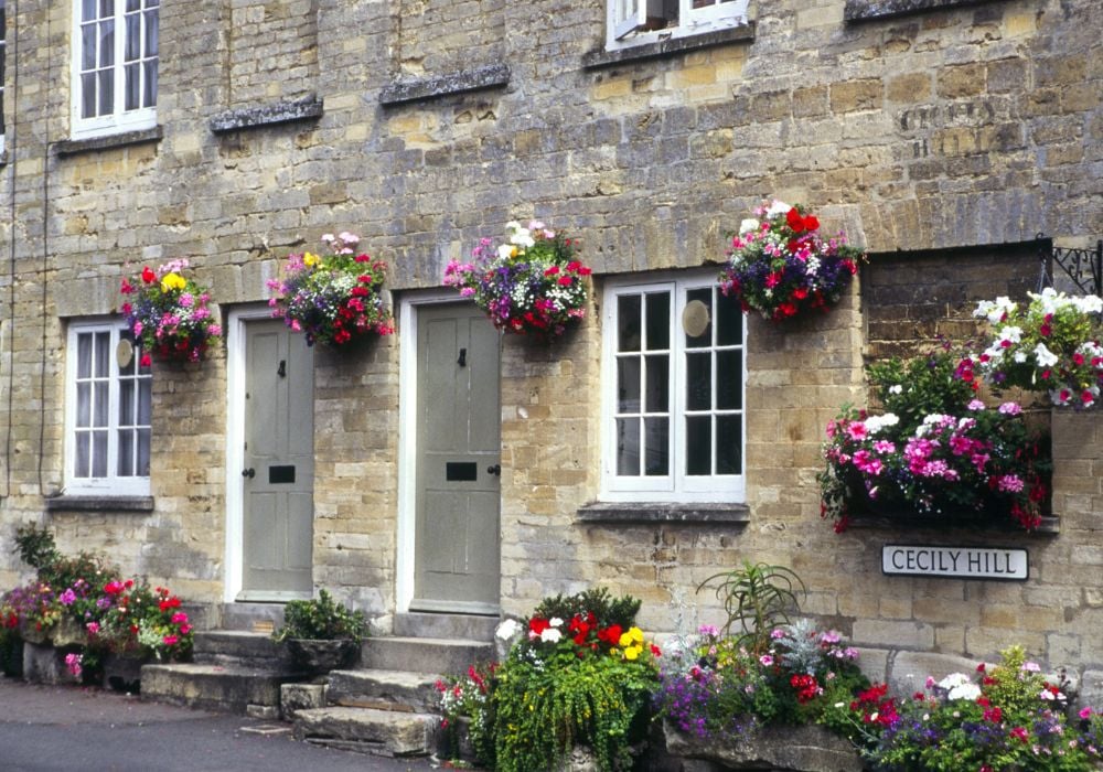 stone homes covered in flowers in cirencester cotswolds england