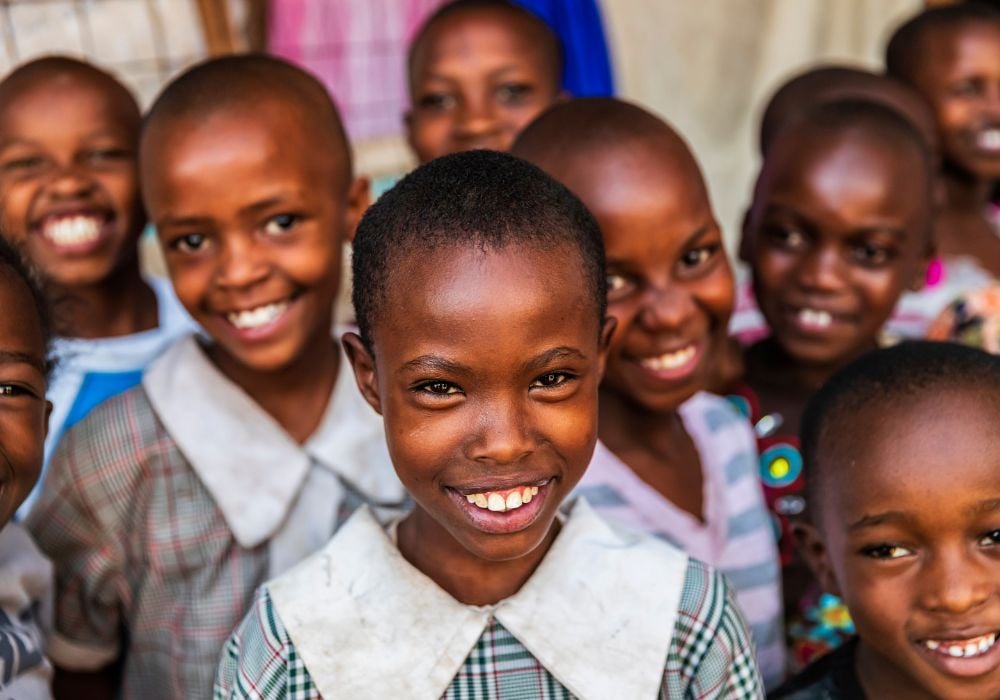 A group of happy children smiling at the camera in the streets of Nairobi, Kenya