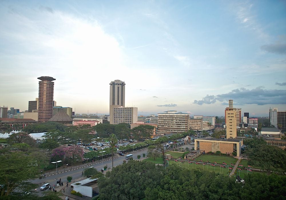 A high-angle image of Nairobi's downtown at dusk, showing skyscrapers and traffic.