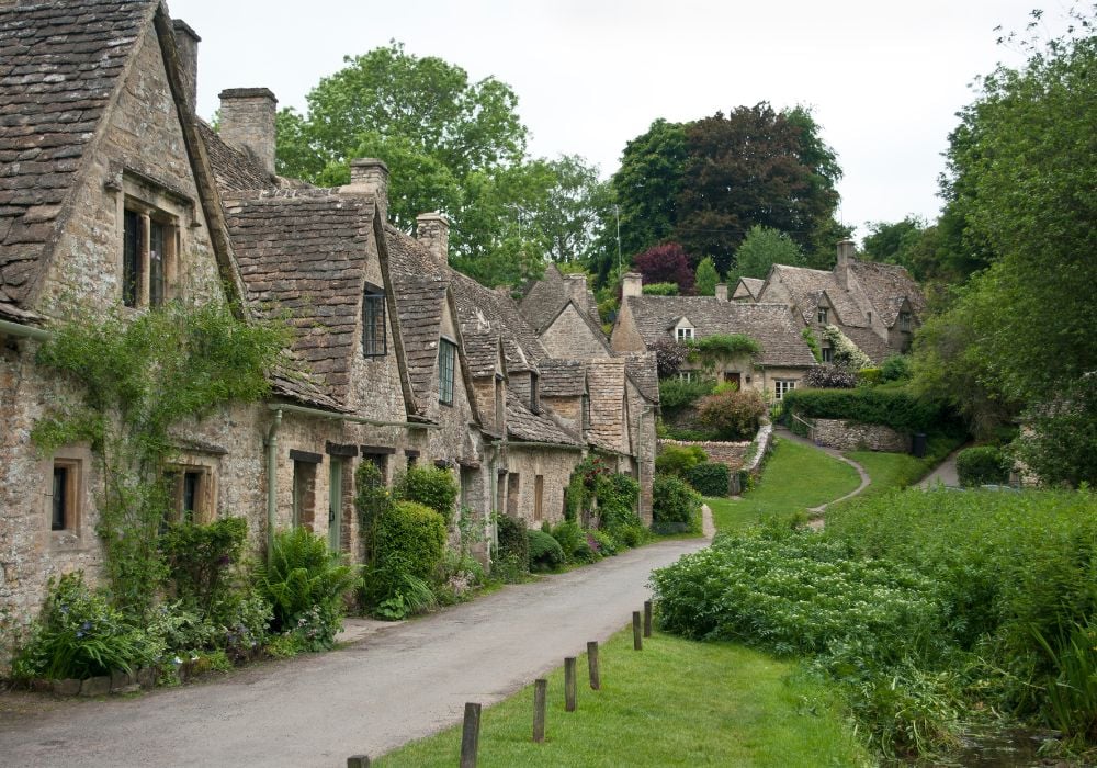 Bibury is a beautiful village with rows of houses in the Cotswolds, England. 